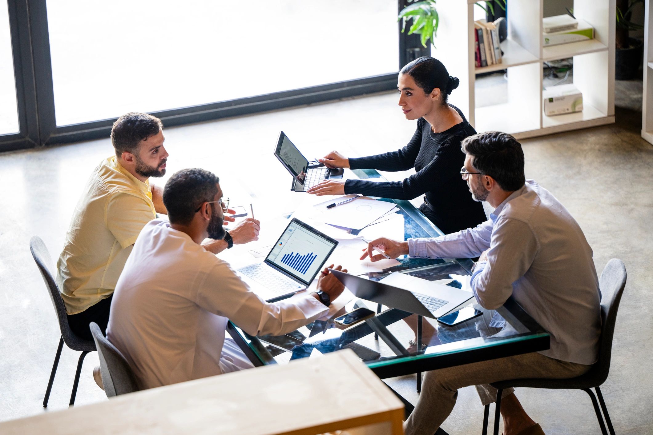 Team meeting in a modern office discussing technology plans